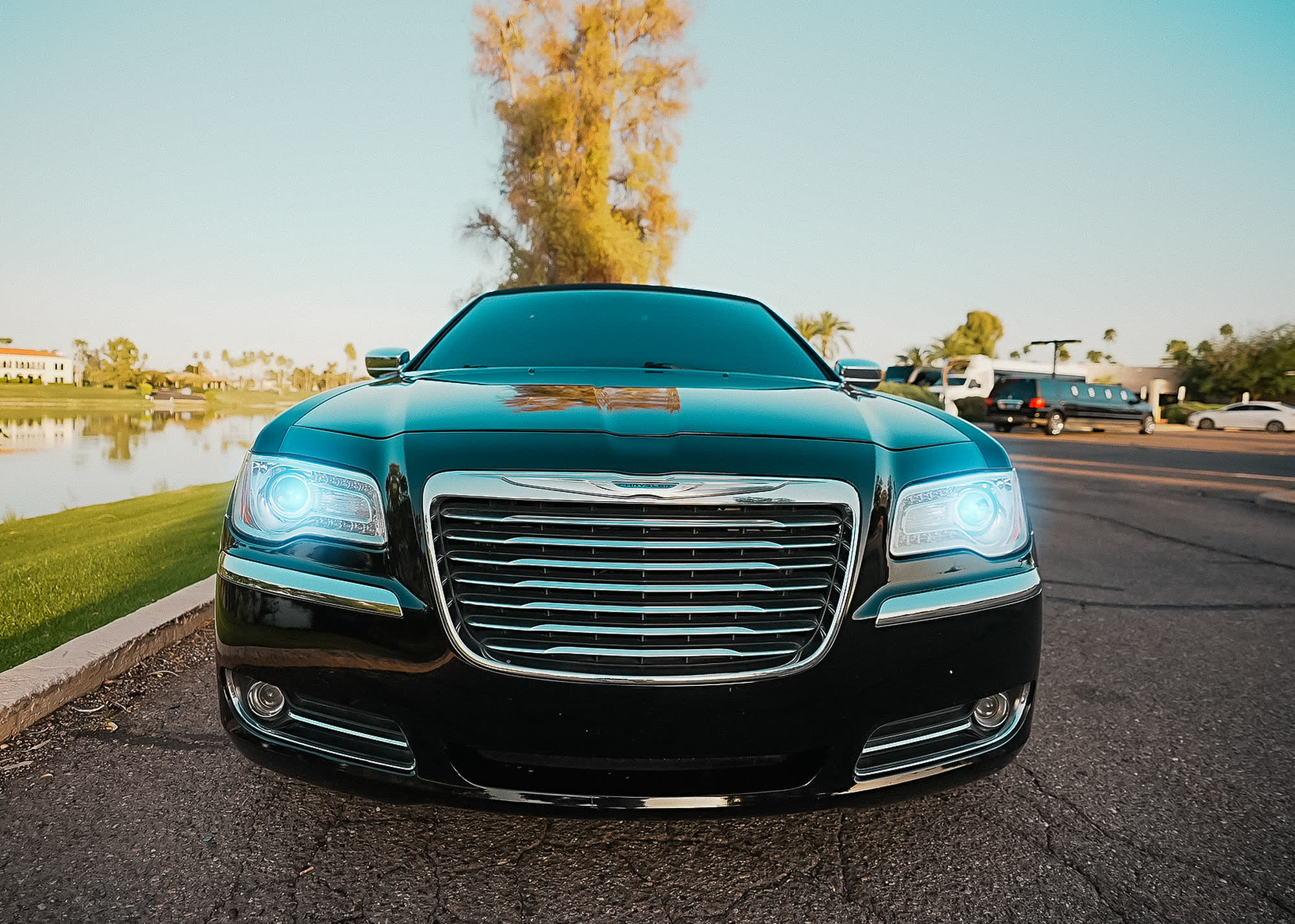 The Chrysler Limo, a black stretch limousine, head-on by the lake